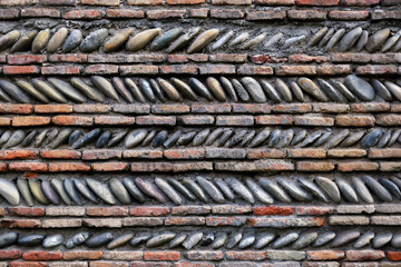 Fragment of the fortress brick wall of an ancient castle.