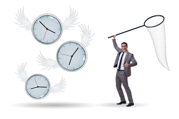 Deadline concept with businessman catching clocks