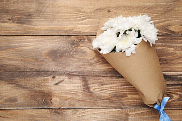 Bouquet of white chrysanthemums on wooden background with copy space. Concept teachers day