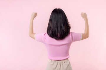 Portrait back of woman proud and confident showing strong muscle strength arms flexed posing, feels about her success achievement. Women empowerment, equality, healthy strength and courage concept