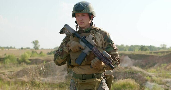 Portrait of military man in army helmet standing and looking around. slow motion , man are trained in combat during basic training