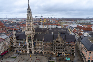 View from the bell tower of the church of saint Peter of the city of Munich, where you can see the cathedral and the town hall, on a cloudy and rainy day.