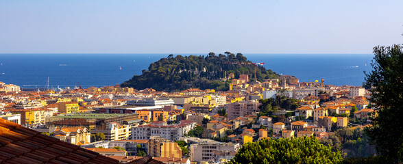 Nice metropolitan view with Colline du Chateau Castle Hill, Mont Boron Mountain, Vielle Ville, Riquier and Port district on French Riviera Azure Coast in France - obrazy, fototapety, plakaty