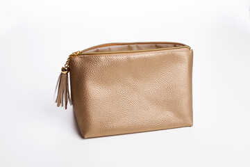Golden pouch for cosmetic beauty products. Luxury cosmetic travel bag on white background