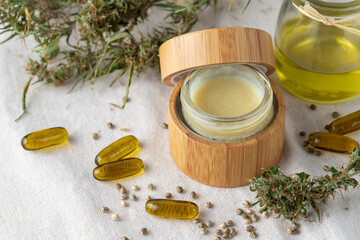 Hemp salve balm jar and relaxing CBD oil capsules as complex in homeopathy  treatment of musculoskeletal or calm nervous system or psoriasis