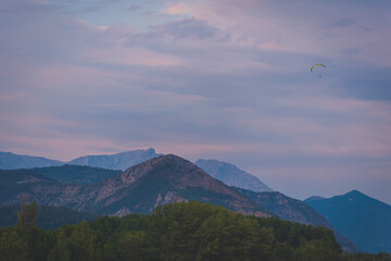 A paraglider in the French Alps during the sunset