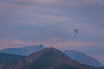 A paraglider in the French Alps during the sunset