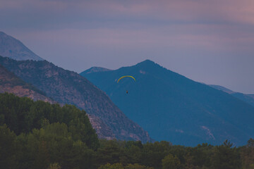 A paraglider in the French Alps during the sunset