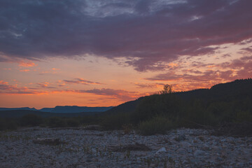 Sunset in a stream bed of a river in the French Alps