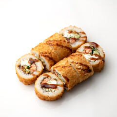 Hot fried Sushi Roll with cream cheese, cucumber, avocado, unagi sauce, baked salmon. Sushi menu. Japanese food. Seafood dishes. White background. Top view. Copy space. High quality photo