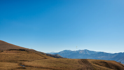 clear blue skies and brown mountains. distant mountain ranges in the haze