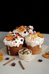 Traditional Easter Cakes decoreted with dried Fruits on Grey Background. Copy space for text