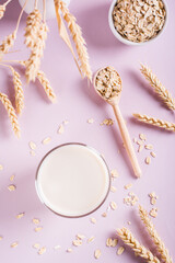 A glass of fresh oat milk and oatmeal. Vegan dairy-free organic drink. Top and vertical view