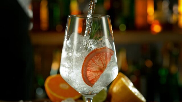 Super Slow Motion Shot of Pouring Gin and Tonic Into Long Glass with Camera Motion at 1000fps.