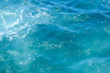 Fototapeta na wymiar Natural background of blue foaming sea water