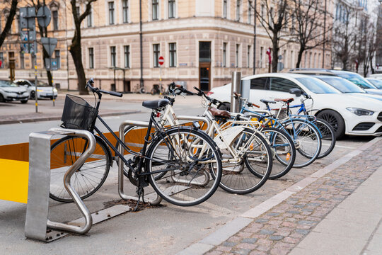 Parked bicycles on the street side for safety and locks