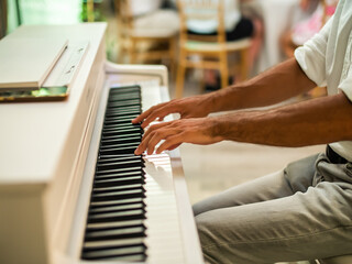 Male pianist hands on grand piano keyboard - music event and artist musician concept