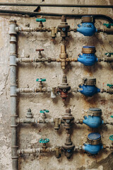 Water pipes with meters outside an old house in Italy