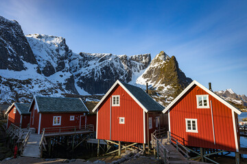 traditional red houses with mountain at the lofoten norway - obrazy, fototapety, plakaty