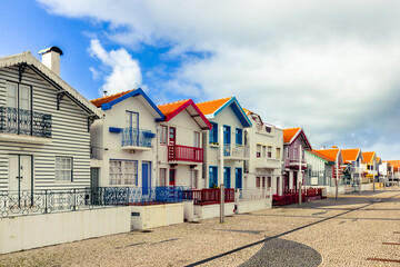 Fototapeta na wymiar Striped colorful houses at the Praia da Costa Nova