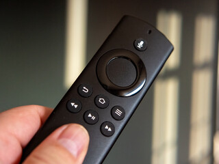 A modern remote control in hand