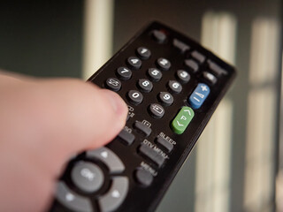 A modern remote control in hand