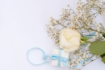 wedding or mothers day background, bouquet with gift box over white background, copy space