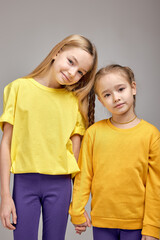 fashion stylish kids posing to camera isolated white background.closeness, warm relationship between sisters