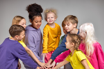 adorable kids joins their hands express their unity, friendship closeness, team is ready to take...