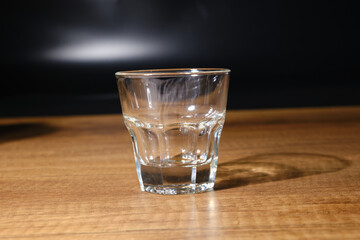 small shot glass close-up on wooden floor