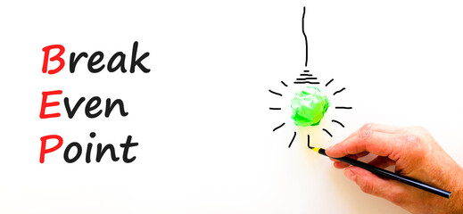 BEP break even point symbol. Concept words BEP break even point on white paper on a beautiful white background. Green light bulb icon. Business and BEP break even point concept. Copy space.