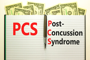 PCS post-concussion syndrome symbol. Concept words PCS post-concussion syndrome on white note on a beautiful background from dollar bills. Medical and PCS post-concussion syndrome concept. Copy space.