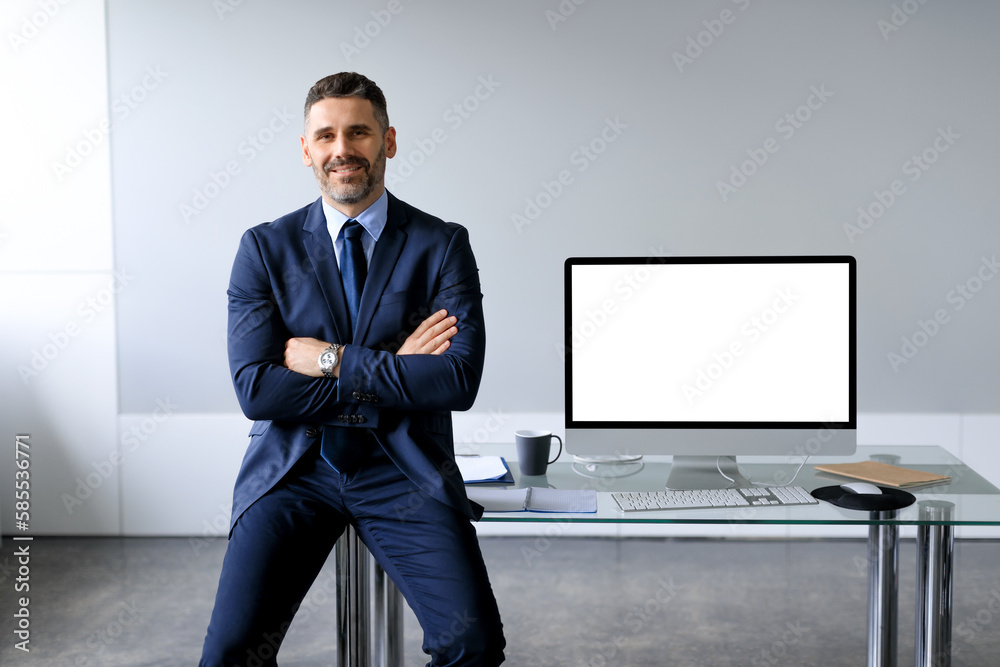 Aufkleber confident middle aged businessman leaning on table, posing with folded arms near computer with blank