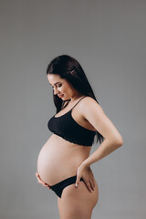 pregnant woman touching her big belly. Close up. Motherhood, pregnancy and expectation concept
