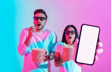 Amazing Offer. Shocked interracial couple with popcorn showing big blank smartphone