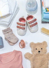 Set of baby shoes, toys and accessories on white background. Newborn stuff. Flat lay, top view