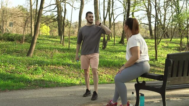 Beautiful overweight female doing exercise with her boyfriend on an early spring day.