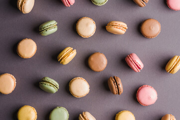 Sweet colorful macarons dessert on a gray background