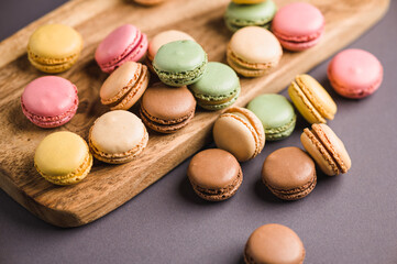 Sweet colorful macarons dessert on a gray background