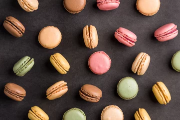 Foto op Canvas Sweet colorful macarons dessert on a black background © buffalo