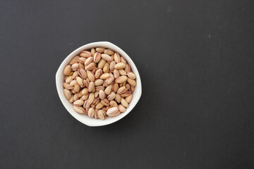 cashew nuts in a bowl on black background 