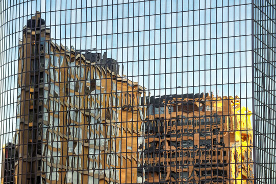 Reflections of abstract buildings on the glass of one of the beautiful huge skyscrapers
