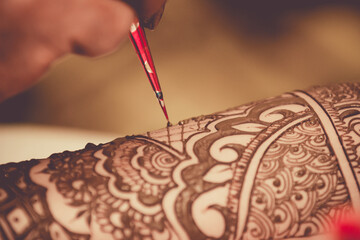 Painting Henna on The Bride's Hands. Wedding Preparation in India. Close up Body Art.