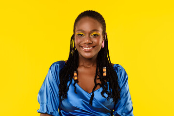 Obraz na płótnie Canvas Portrait Of African Lady With Bright Makeup On Yellow Background