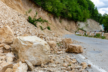 Limestone rockfall and landslide fallen and blocking tarmac road leading to Khvamli Mountain peak...