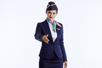 Obraz na płótnie Canvas stylish female air hostess on white giving hand for handshake