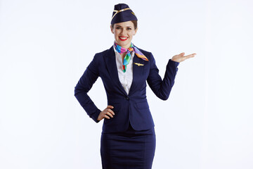 Obraz na płótnie Canvas happy female air hostess on presenting something on empty palm