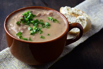 Delicious dish of Brazilian cuisine called Caldo de Feijão. Made with black beans, bacon and sausage. Bean broth.