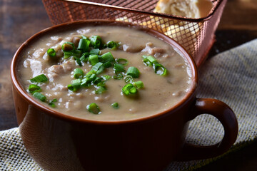 Delicious dish of Brazilian cuisine called Caldo de Feijão. Made with black beans, bacon and sausage. Bean broth.