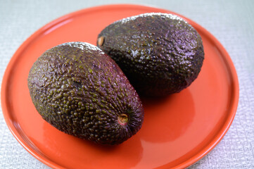 Two fresh ripe raw hass avocados, close up, healthy food concept
